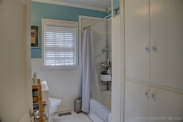 full bathroom featuring toilet, shower / tub combo, visible vents, tile walls, and ornamental molding