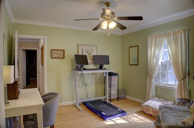 exercise room featuring baseboards, ceiling fan, light wood finished floors, and crown molding