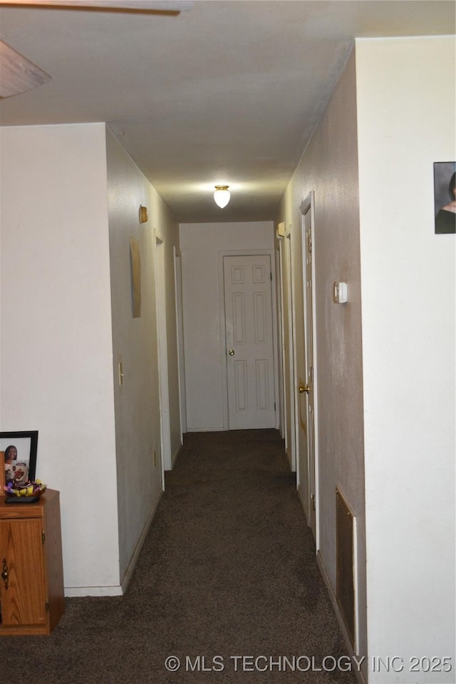 hall with dark carpet and visible vents