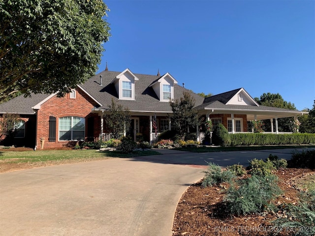 view of front of property featuring concrete driveway and brick siding