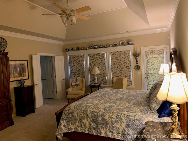 carpeted bedroom featuring a ceiling fan, lofted ceiling, a raised ceiling, and crown molding