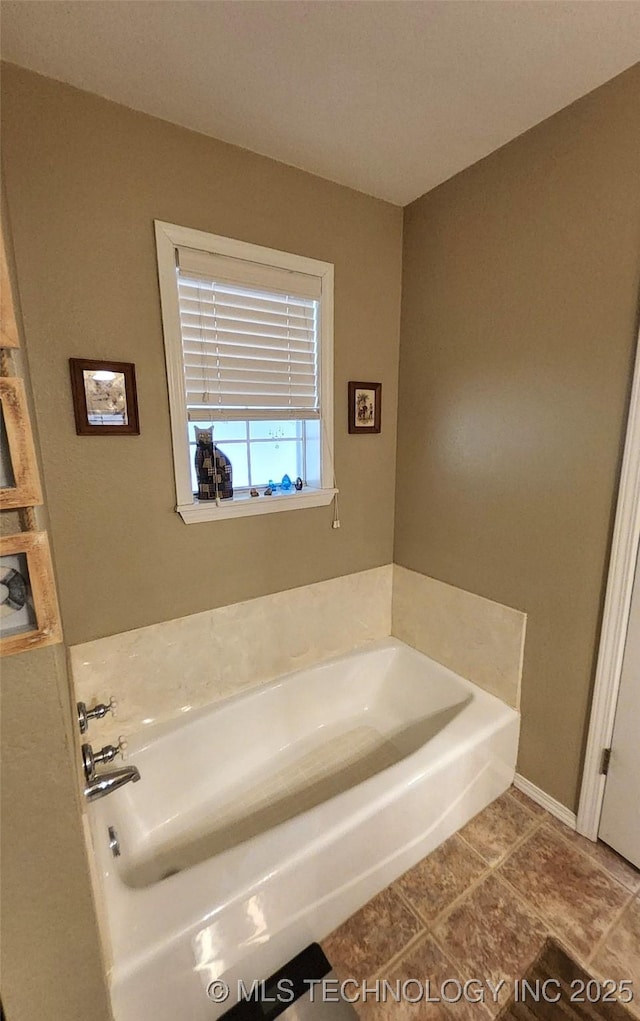 full bathroom featuring a bath and tile patterned flooring