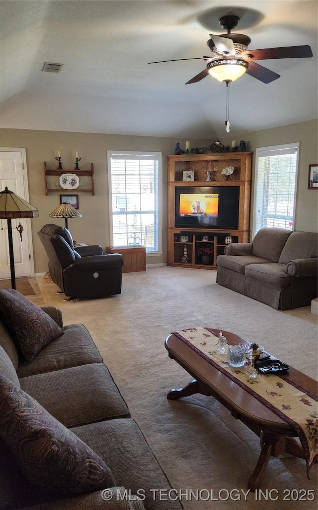 living room featuring ceiling fan, carpet, visible vents, and a healthy amount of sunlight