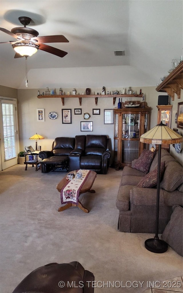 carpeted living room with ceiling fan and visible vents