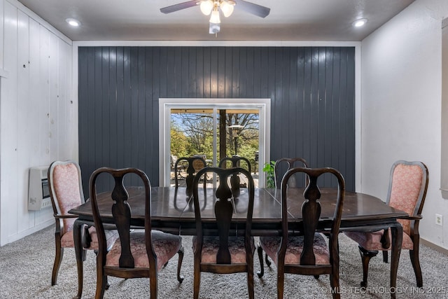 carpeted dining room with baseboards, ceiling fan, and heating unit