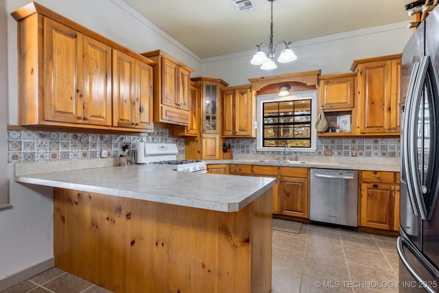 kitchen featuring light countertops, white range with gas cooktop, a peninsula, and stainless steel dishwasher