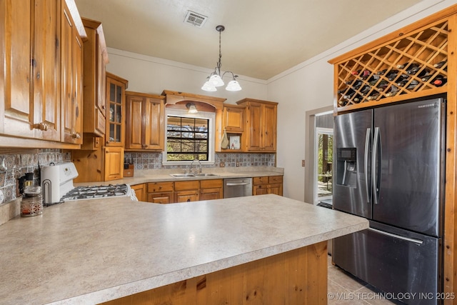 kitchen featuring stainless steel appliances, a peninsula, and light countertops