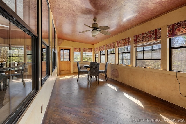 sunroom featuring a ceiling fan and vaulted ceiling