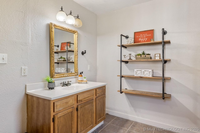 bathroom featuring tile patterned flooring, baseboards, and vanity