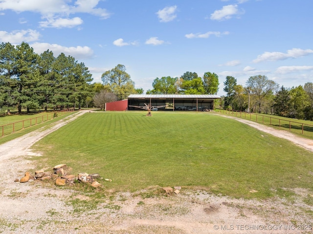 view of front of property with a rural view and fence