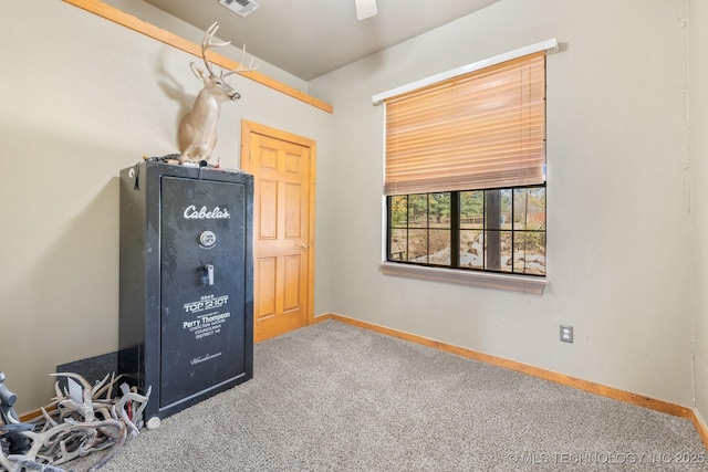 unfurnished room with carpet flooring, visible vents, and baseboards