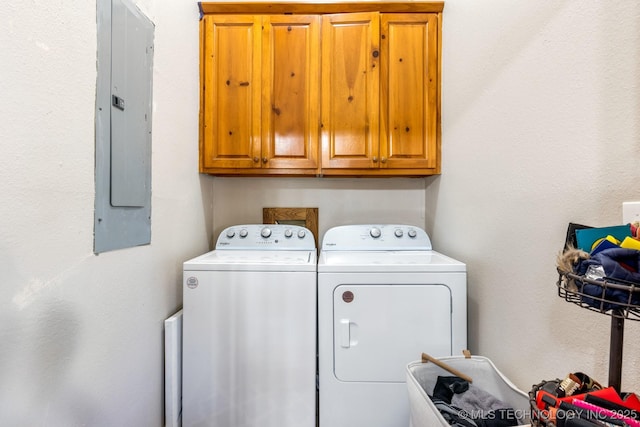 washroom with independent washer and dryer, electric panel, and cabinet space