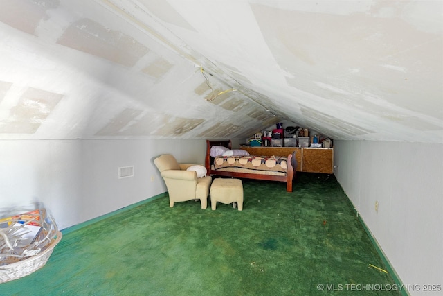 bedroom featuring dark colored carpet and lofted ceiling