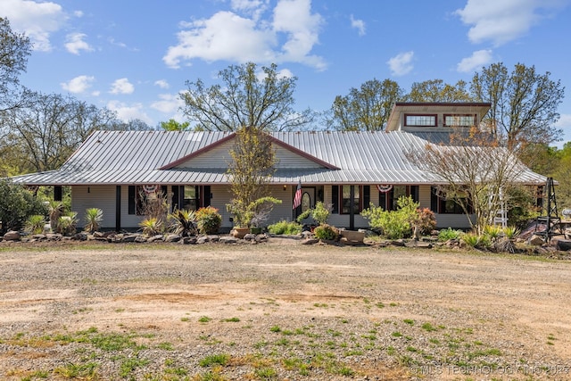 view of front of home with covered porch and metal roof