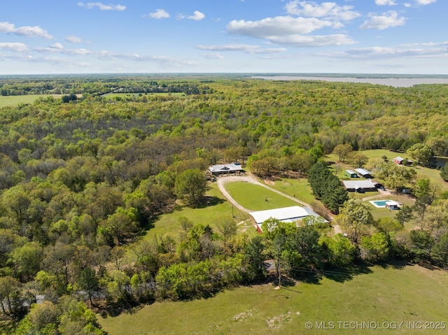 birds eye view of property featuring a view of trees