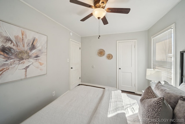 bedroom featuring ceiling fan and baseboards