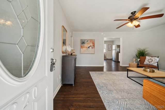 foyer featuring dark wood-style floors, baseboards, and a ceiling fan