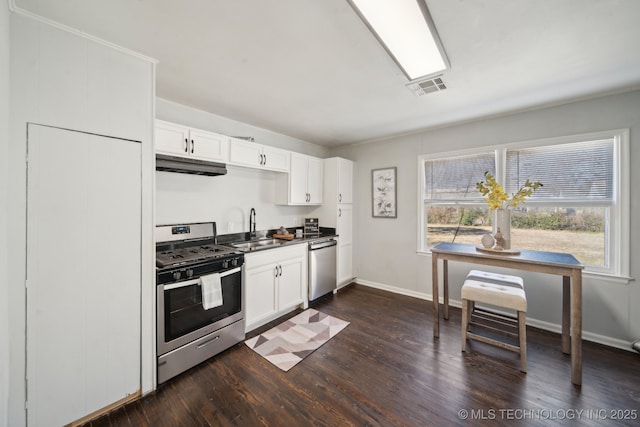 kitchen with visible vents, white cabinets, appliances with stainless steel finishes, under cabinet range hood, and a sink