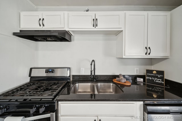 kitchen with under cabinet range hood, stainless steel gas range, white cabinets, and a sink