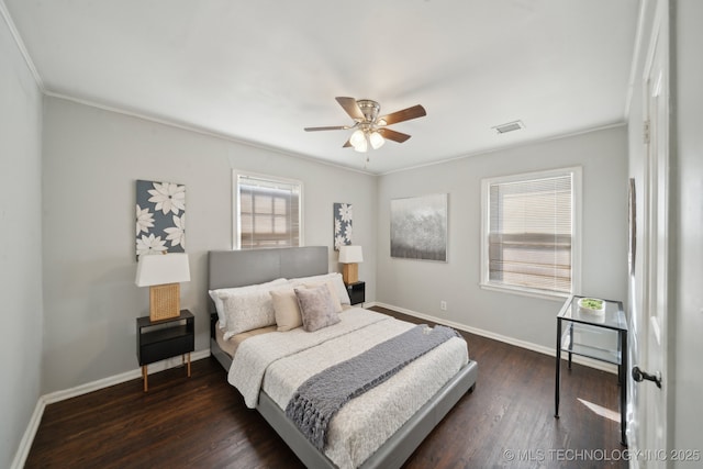 bedroom with visible vents, dark wood finished floors, and baseboards