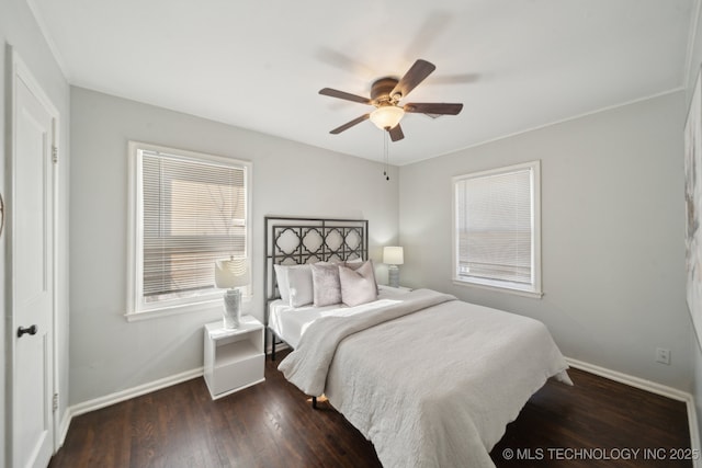 bedroom featuring wood finished floors, a ceiling fan, and baseboards