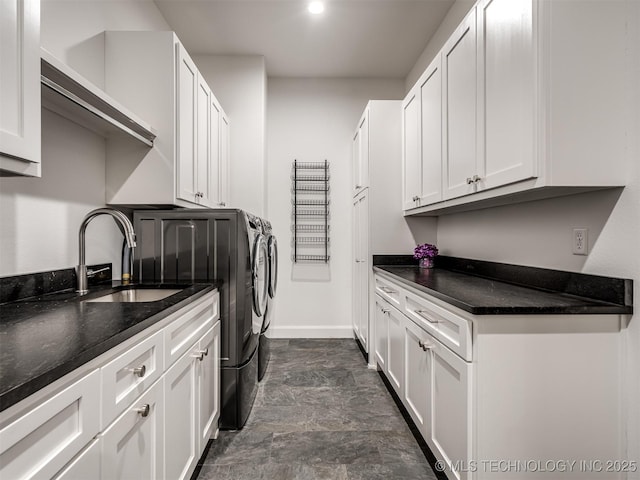 18420 E Persimmon Ln, Owasso, OK 74055 - laundry room featuring separate washer and dryer, cabinet space, and stone finish flooring