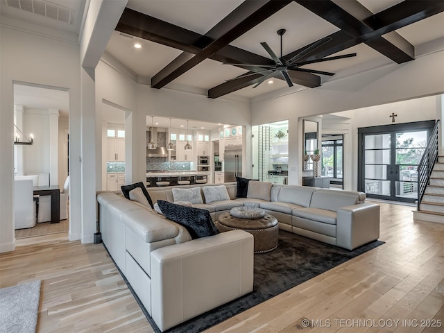18420 E Persimmon Ln, Owasso, OK 74055 - living room featuring light wood-style floors, coffered ceiling, beamed ceiling, ceiling fan, and stairway