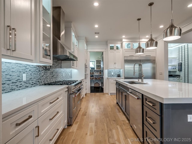 18420 E Persimmon Ln, Owasso, OK 74055 - kitchen with premium appliances, wall chimney range hood, light countertops, white cabinetry, and recessed lighting