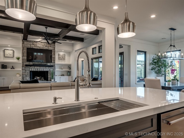 18420 E Persimmon Ln, Owasso, OK 74055 - kitchen featuring ceiling fan, a fireplace, hanging light fixtures, recessed lighting, and light countertops