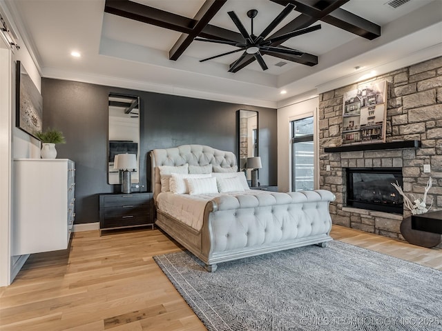 18420 E Persimmon Ln, Owasso, OK 74055 - bedroom with coffered ceiling, light wood finished floors, a fireplace, recessed lighting, and beamed ceiling