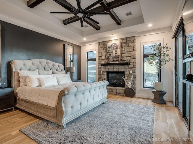 18420 E Persimmon Ln, Owasso, OK 74055 - bedroom featuring coffered ceiling, light wood-type flooring, recessed lighting, a fireplace, and beam ceiling