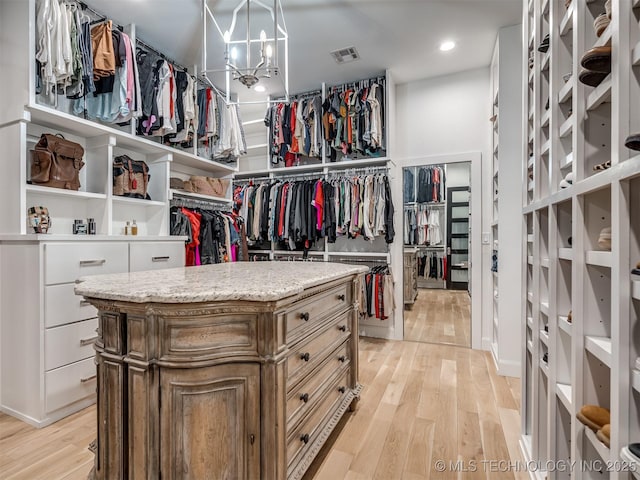 18420 E Persimmon Ln, Owasso, OK 74055 - spacious closet with light wood-style flooring and a chandelier