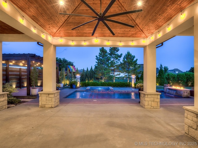 18420 E Persimmon Ln, Owasso, OK 74055 - pool at twilight with an in-ground hot tub, ceiling fan, an outdoor pool, and a patio area