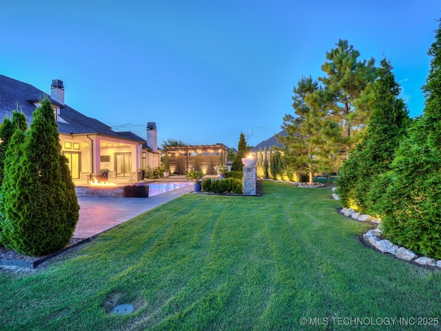 18420 E Persimmon Ln, Owasso, OK 74055 - view of green lawn with a patio area and an outdoor fire pit