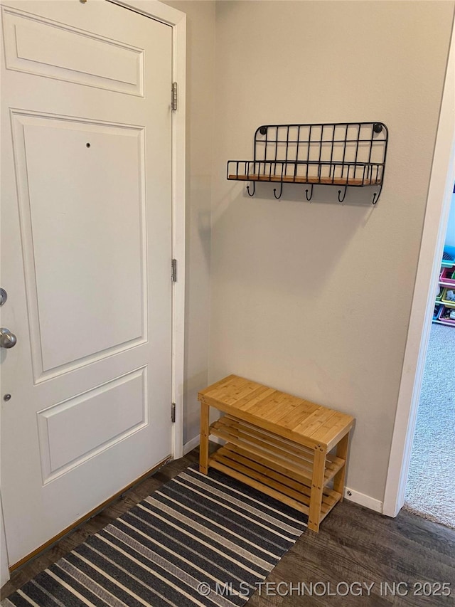 mudroom featuring dark wood-style floors and baseboards