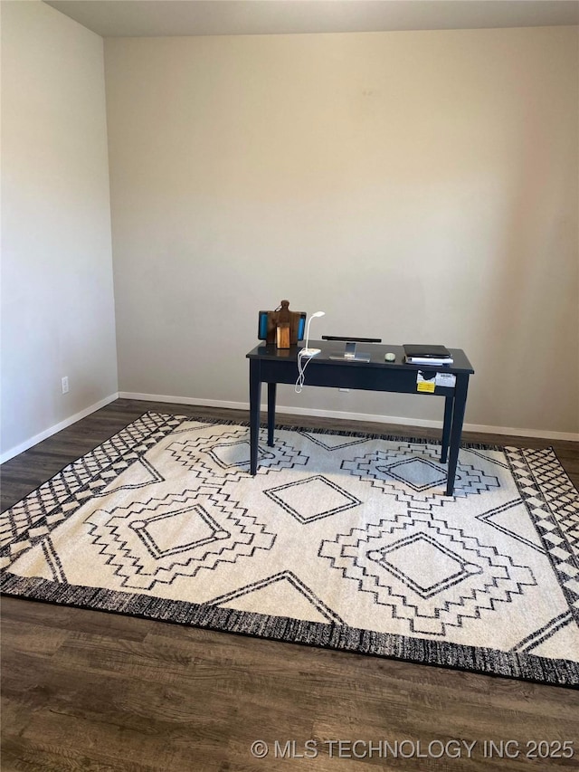 office space featuring baseboards and wood finished floors