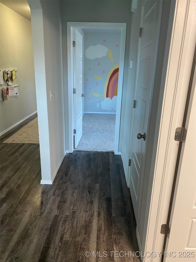 hall featuring dark wood-style floors and baseboards