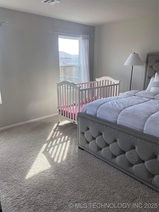 bedroom with carpet floors, visible vents, and baseboards