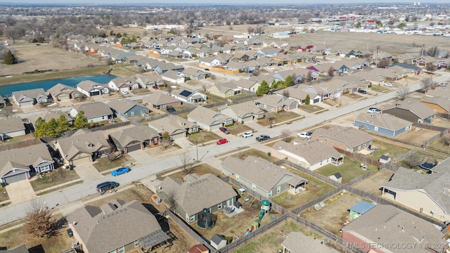 drone / aerial view with a residential view and a water view