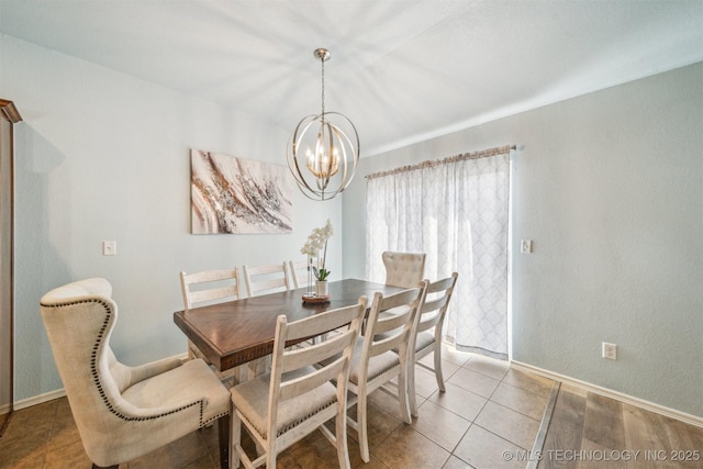 dining area featuring light tile patterned flooring, baseboards, and an inviting chandelier