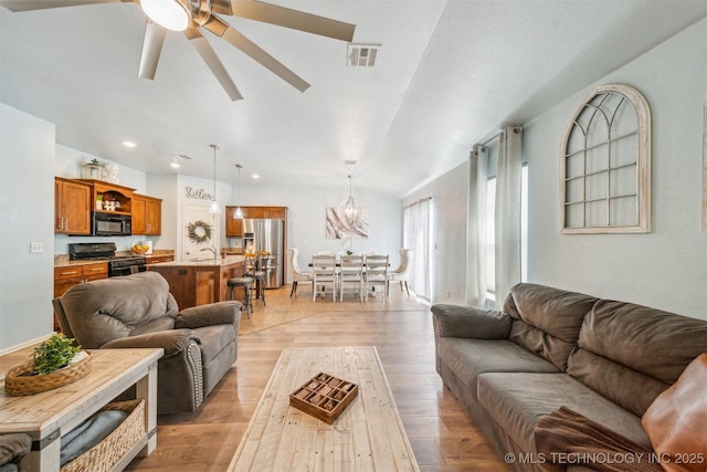 living room with light wood finished floors, visible vents, a ceiling fan, and recessed lighting