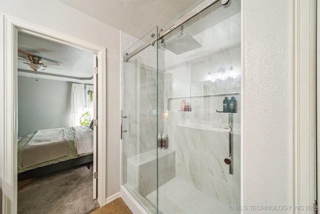 ensuite bathroom with a stall shower, a ceiling fan, a textured ceiling, and ensuite bathroom