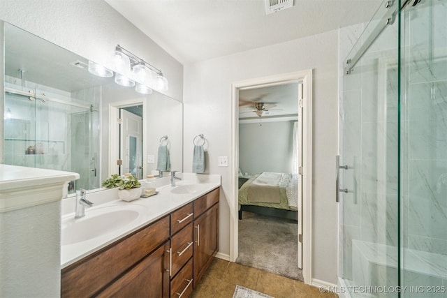 ensuite bathroom featuring a stall shower, visible vents, a sink, and ensuite bathroom