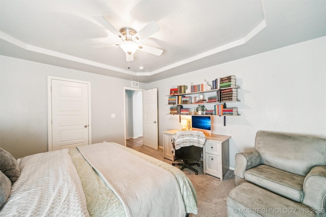 bedroom featuring a raised ceiling, light carpet, ceiling fan, and visible vents