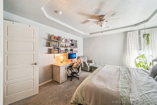 bedroom featuring a raised ceiling, light colored carpet, visible vents, a ceiling fan, and baseboards