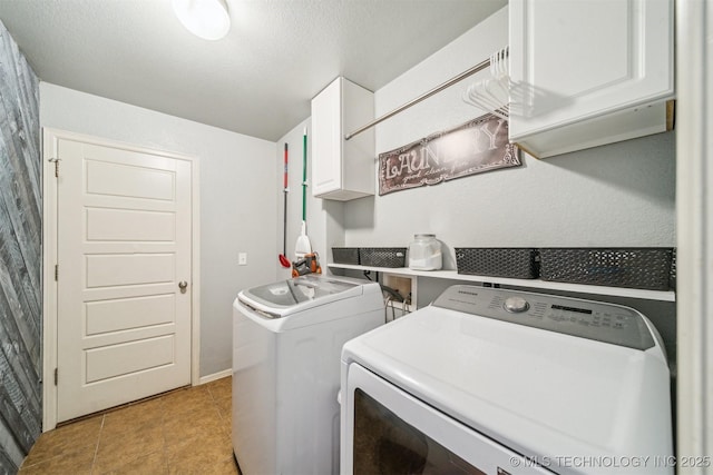 washroom featuring light tile patterned flooring, cabinet space, and washer and dryer