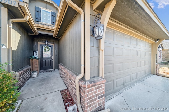 entrance to property featuring driveway and an attached garage