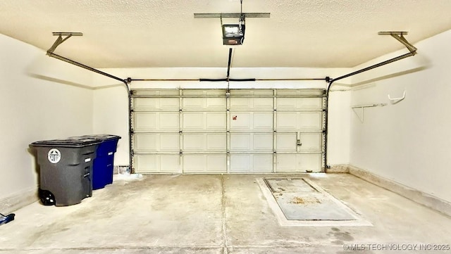 garage featuring baseboards and a garage door opener