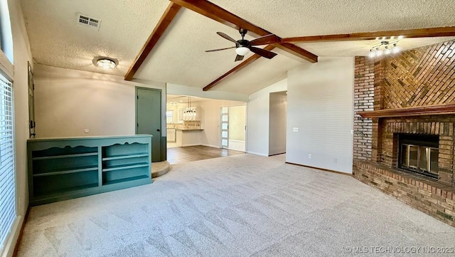 carpeted living area with vaulted ceiling with beams, a brick fireplace, visible vents, and a textured ceiling