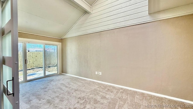 spare room featuring carpet floors, lofted ceiling with beams, and baseboards